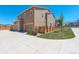 Exterior view of home featuring attached garages, green lawn, and wooden fence at 4316 S Netherland St, Aurora, CO 80015