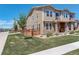 Well-maintained townhouse with a lush lawn, fenced yard, and sidewalk access at 4316 S Netherland St, Aurora, CO 80015
