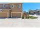 Exterior shot of a two-car garage with ample driveway parking and a well-maintained lawn at 4316 S Netherland St, Aurora, CO 80015