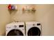 Bright laundry room with a front loading washer and front loading dryer, includes shelf at 4316 S Netherland St, Aurora, CO 80015