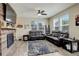Bright living room with wood-look floors, a fireplace, and comfortable seating at 4316 S Netherland St, Aurora, CO 80015