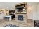 Open-concept living space featuring a fireplace, breakfast bar, and easy access to the kitchen at 4316 S Netherland St, Aurora, CO 80015