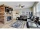 Cozy living room featuring a fireplace, ceiling fan, comfortable seating, and ample natural light at 4316 S Netherland St, Aurora, CO 80015