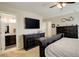 This main bedroom includes tan carpet, a ceiling fan and dark wood furniture at 4316 S Netherland St, Aurora, CO 80015