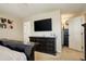 Main bedroom featuring a large bed and dresser with an ensuite bathroom and a TV at 4316 S Netherland St, Aurora, CO 80015