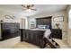 Spacious main bedroom featuring a large dark wood bed and bedside tables at 4316 S Netherland St, Aurora, CO 80015