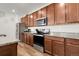 Updated kitchen featuring granite countertops, stainless steel appliances, and sleek wood cabinets at 4358 S Nepal Ct, Centennial, CO 80015