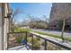 Cozy balcony with black railing, offering a view of the street and surrounding neighborhood in a quiet setting at 5677 S Park Pl # A102, Englewood, CO 80111