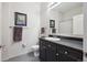 Modern bathroom featuring a dark vanity, white sink, and neutral wall decor for a clean, contemporary style at 5677 S Park Pl # A102, Englewood, CO 80111