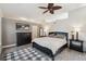 Cozy bedroom with ceiling fan, natural lighting, modern decor and gray flooring at 5677 S Park Pl # A102, Englewood, CO 80111