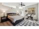 Bedroom with hardwood floors, fan, and an exercise bike near large window at 5677 S Park Pl # A102, Englewood, CO 80111