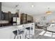 Stylish kitchen and living room featuring bar seating, hardwood floors and stainless steel appliances at 5677 S Park Pl # A102, Englewood, CO 80111