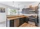Well-equipped kitchen featuring stainless steel appliances, dark wood cabinets, and a functional layout for cooking and entertaining at 5677 S Park Pl # A102, Englewood, CO 80111