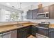 This modern kitchen features granite countertops and stainless steel appliances with ample natural light at 5677 S Park Pl # A102, Englewood, CO 80111