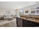 Open-concept living room and kitchen area featuring modern appliances and plenty of natural light at 5677 S Park Pl # A102, Englewood, CO 80111