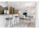 The open living area offers barstool seating, dining space, and a comfortable lounge area at 5677 S Park Pl # A102, Englewood, CO 80111