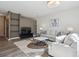 Cozy living room with comfortable seating, TV, stylish rug, decor, and wall shelving at 5677 S Park Pl # A102, Englewood, CO 80111