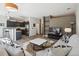 Comfortable living room featuring adjacent modern kitchen, TV, sofa, and stylish decor at 5677 S Park Pl # A102, Englewood, CO 80111