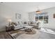 Bright living room with comfortable seating, large window, stylish rug, and contemporary decor at 5677 S Park Pl # A102, Englewood, CO 80111
