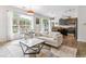 Stylish living room featuring a comfortable sofa, modern coffee table, and ample natural light from the large window at 5677 S Park Pl # A102, Englewood, CO 80111