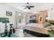 A serene bedroom with a ceiling fan, exercise bike, and a window view at 5677 S Park Pl # A102, Englewood, CO 80111