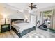 A cozy bedroom with a ceiling fan, bedside tables, and a window view at 5677 S Park Pl # A102, Englewood, CO 80111