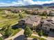 Stunning aerial view of a home with lush landscaping in a desirable community and mountain views at 2373 S Joyce St, Denver, CO 80228