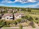 Aerial view of a home with a tiled roof, surrounded by lush landscaping and community greenery at 2373 S Joyce St, Denver, CO 80228