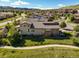 Aerial view of a house with a tile roof in a neighborhood with mature trees and green spaces at 2373 S Joyce St, Denver, CO 80228