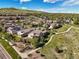 Aerial view of a residential community surrounded by lush landscaping and a winding walking path at 2373 S Joyce St, Denver, CO 80228