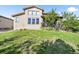 Expansive backyard featuring a well-kept lawn, complemented by the house's architecture at 2373 S Joyce St, Denver, CO 80228