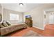 Comfortable bedroom featuring a TV, window with natural light, and neutral color flooring at 2373 S Joyce St, Denver, CO 80228