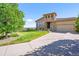 Charming home with a stone facade, well-maintained lawn, and a two-car garage at 2373 S Joyce St, Denver, CO 80228