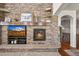 Stone fireplace wall with built-ins and fireplace insert at 2373 S Joyce St, Denver, CO 80228