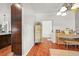 Inviting hallway with hardwood floors, decorative screen, and access to the living spaces at 2373 S Joyce St, Denver, CO 80228