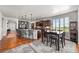 Spacious eat-in kitchen featuring an island, wood floors, granite countertops, and stainless appliances at 2373 S Joyce St, Denver, CO 80228