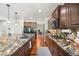 Long shot of stunning kitchen with granite counters, hardwood floors, and stainless steel appliances at 2373 S Joyce St, Denver, CO 80228