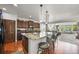 Open concept kitchen with island, granite counters, stainless appliances and seamless flow to living area at 2373 S Joyce St, Denver, CO 80228