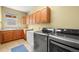 Functional laundry room with modern washer and dryer, ample cabinetry, and a built-in sink at 2373 S Joyce St, Denver, CO 80228