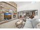 Inviting living room featuring a stone fireplace, neutral carpet, and a view into the kitchen at 2373 S Joyce St, Denver, CO 80228