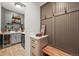 Functional mudroom with storage cabinets, coat hooks, bench, and drink refrigerators at 2373 S Joyce St, Denver, CO 80228