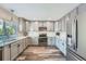 Beautiful kitchen with modern gray cabinets, stainless steel appliances, and quartz countertops, designed for functionality at 16685 Trail Sky Cir, Parker, CO 80134