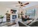 Cozy living room features a fireplace, ceiling fan, and plenty of natural light at 16685 Trail Sky Cir, Parker, CO 80134