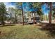Exterior shot of the home featuring a large treed lot at 5382 S Pine Rd, Evergreen, CO 80439