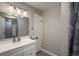 Clean and modern bathroom with a white vanity, large mirror, and shower/tub combo at 5382 S Pine Rd, Evergreen, CO 80439