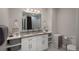 Bright bathroom featuring a double sink vanity with granite countertop, modern fixtures and stylish accents at 5382 S Pine Rd, Evergreen, CO 80439