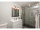 Modern bathroom featuring a glass-enclosed shower, and updated vanity with stylish fixtures and lighting at 5382 S Pine Rd, Evergreen, CO 80439