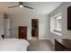 Spacious bedroom featuring a ceiling fan, walk-in closet, and abundant natural light from the window at 5382 S Pine Rd, Evergreen, CO 80439