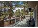 Large, covered deck with outdoor seating, providing a serene setting amidst towering trees at 5382 S Pine Rd, Evergreen, CO 80439