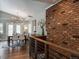 Elegant dining area with vaulted ceiling and exposed brick, bathed in natural light from oversized windows at 5382 S Pine Rd, Evergreen, CO 80439